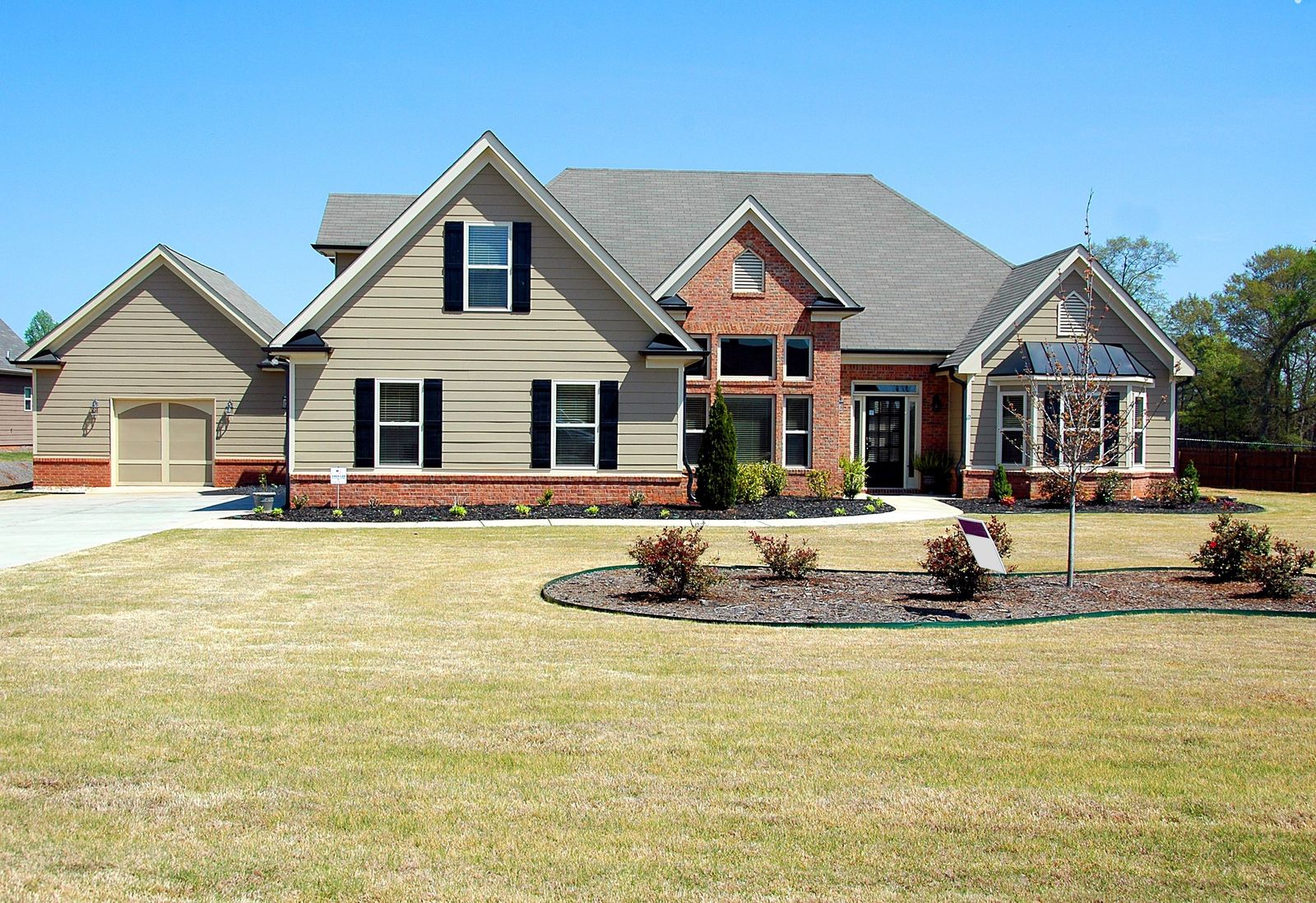 Large suburban home with a wide, freshly cut lawn